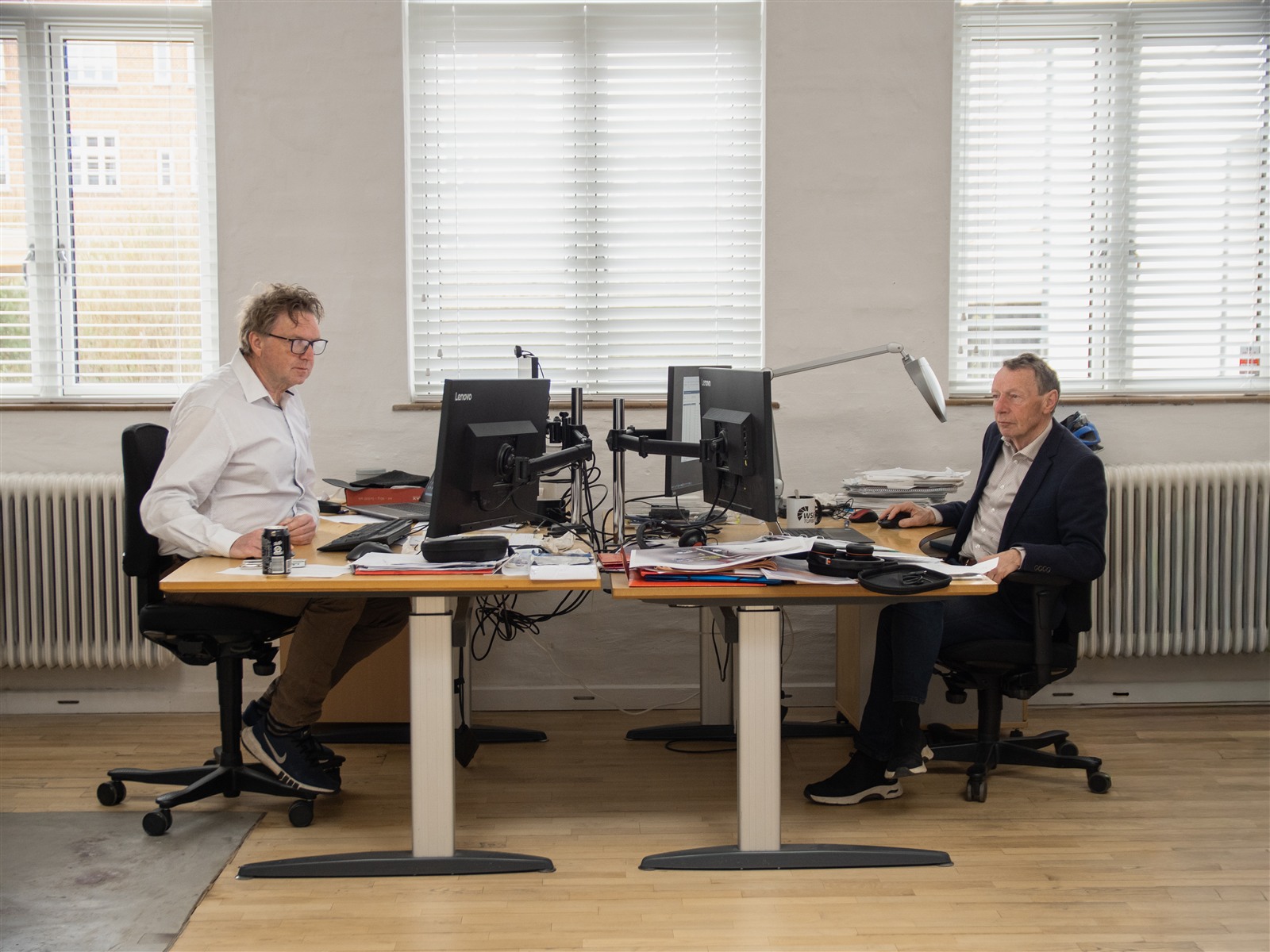 Two consultants working together at their desks in the office