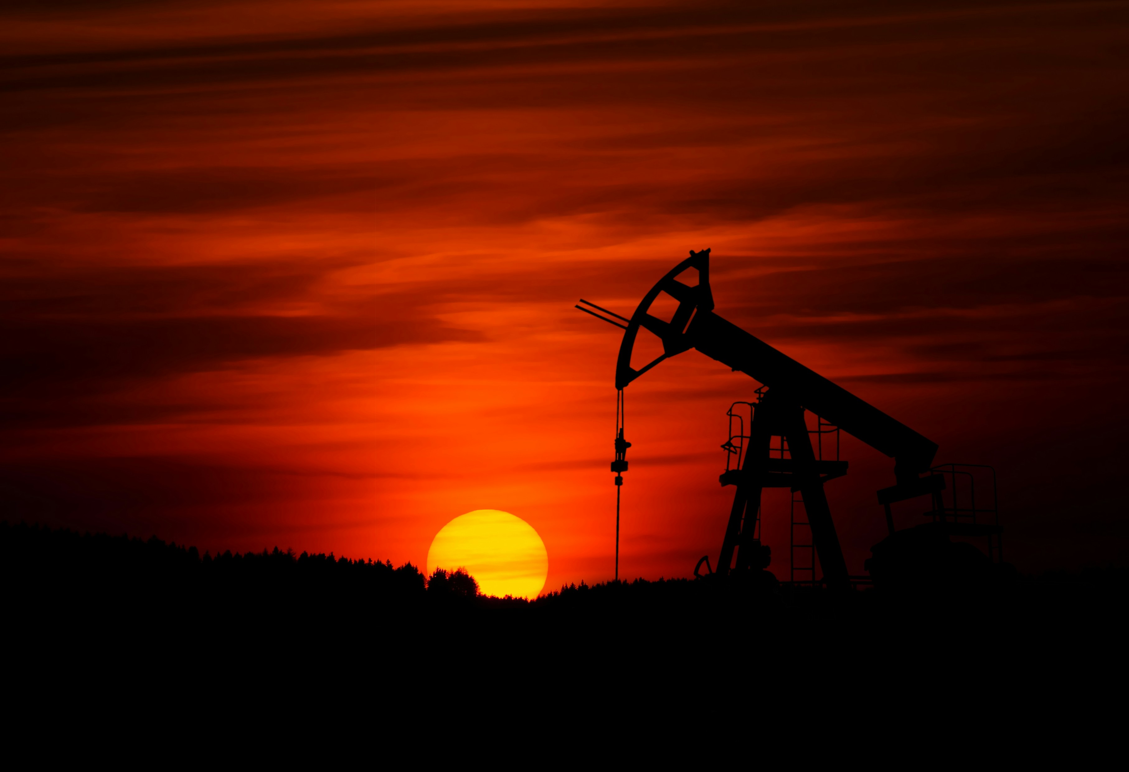Oil pumpjack silhouette at sunset